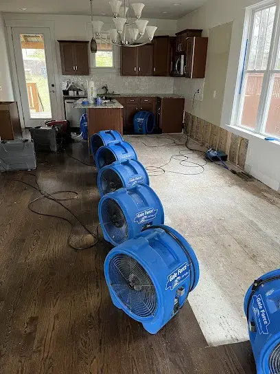 Row of air movers drying a kitchen and hardwood floor